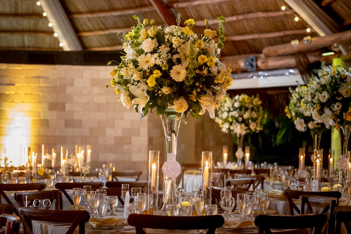 Elevated garden-style wedding centerpiece with candlelight