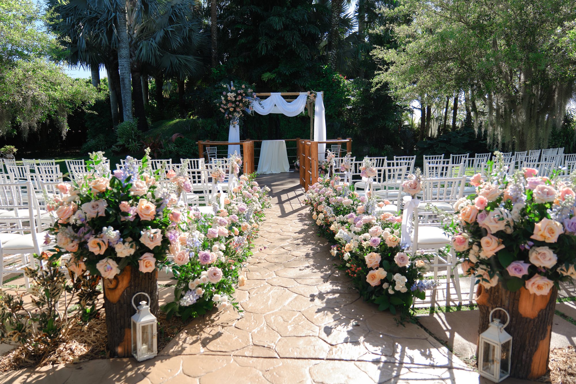 A romantic blush and ivory floral ceremony aisle at Longan’s Place
